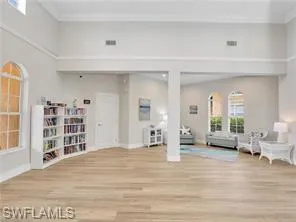 a view of a livingroom with wooden floor and furniture