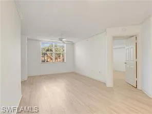 an empty room with windows and cabinet