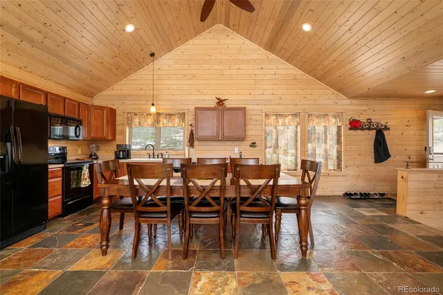 a dinning table and chairs in a open kitchen