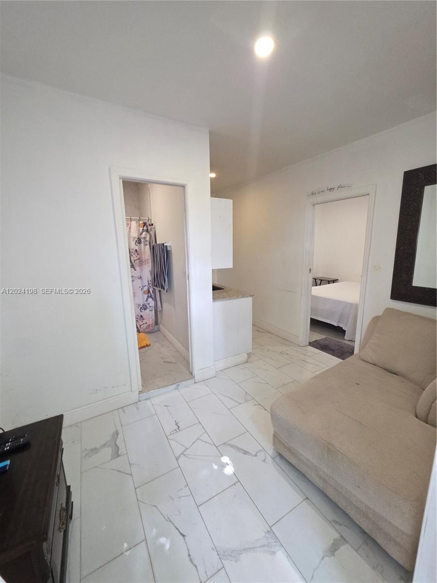 651 East 48th Street Hialeah, FL 33013 - Photo 34 of 52 a living room with furniture and a rug