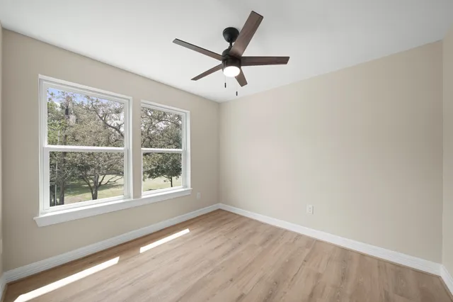 wooden floor in an empty room with a window