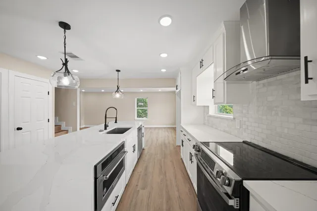 a kitchen with granite countertop a stove and a sink