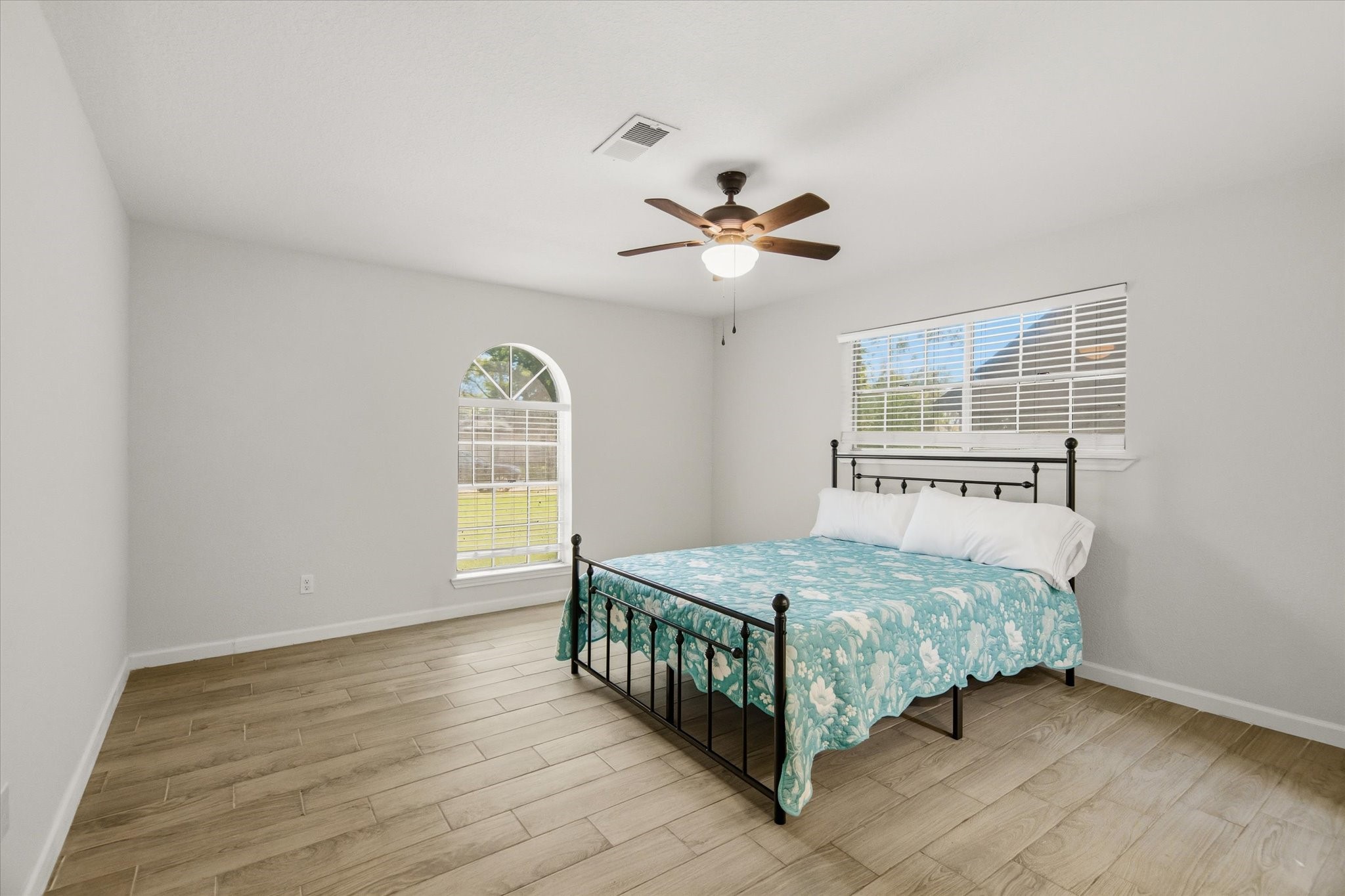 113 Rose Trail Lake Jackson, TX 77566 - Photo 18 of 45 a bedroom with a bed chandelier and a window