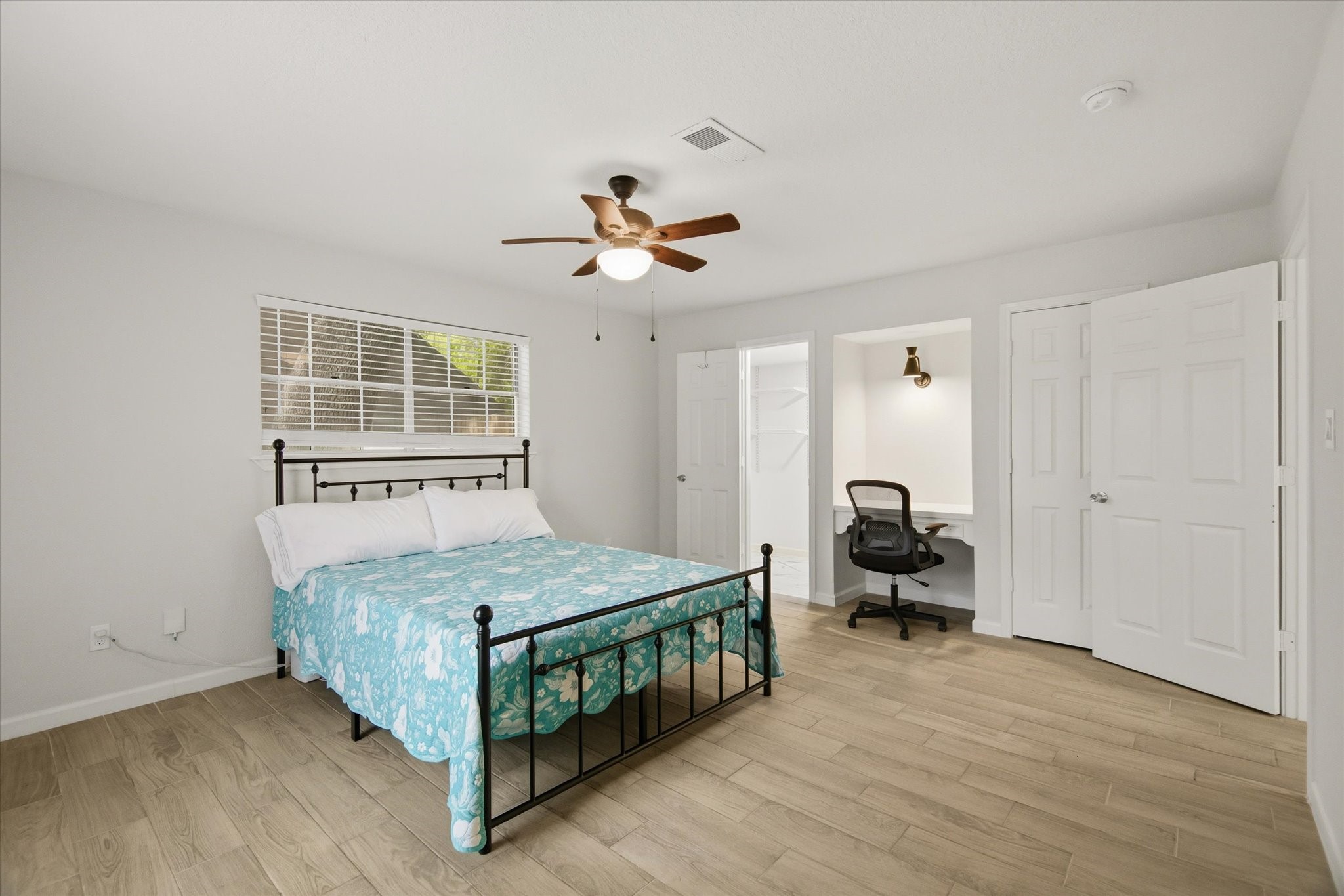 113 Rose Trail Lake Jackson, TX 77566 - Photo 19 of 45 a bedroom with a bed and a chandelier
