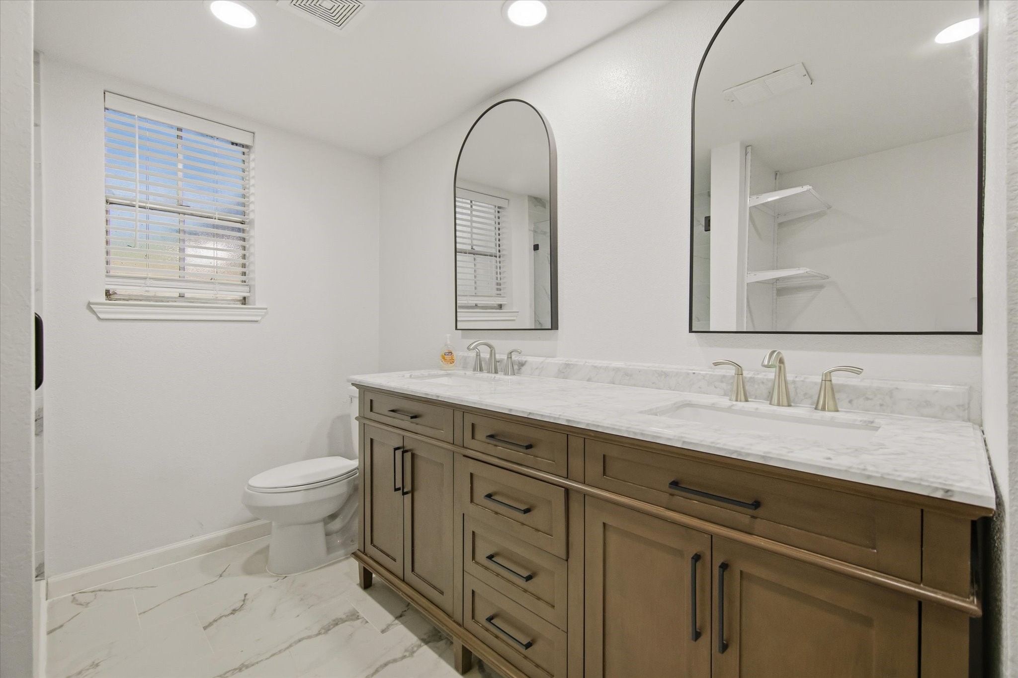 113 Rose Trail Lake Jackson, TX 77566 - Photo 20 of 45 a bathroom with a granite countertop toilet sink and mirror