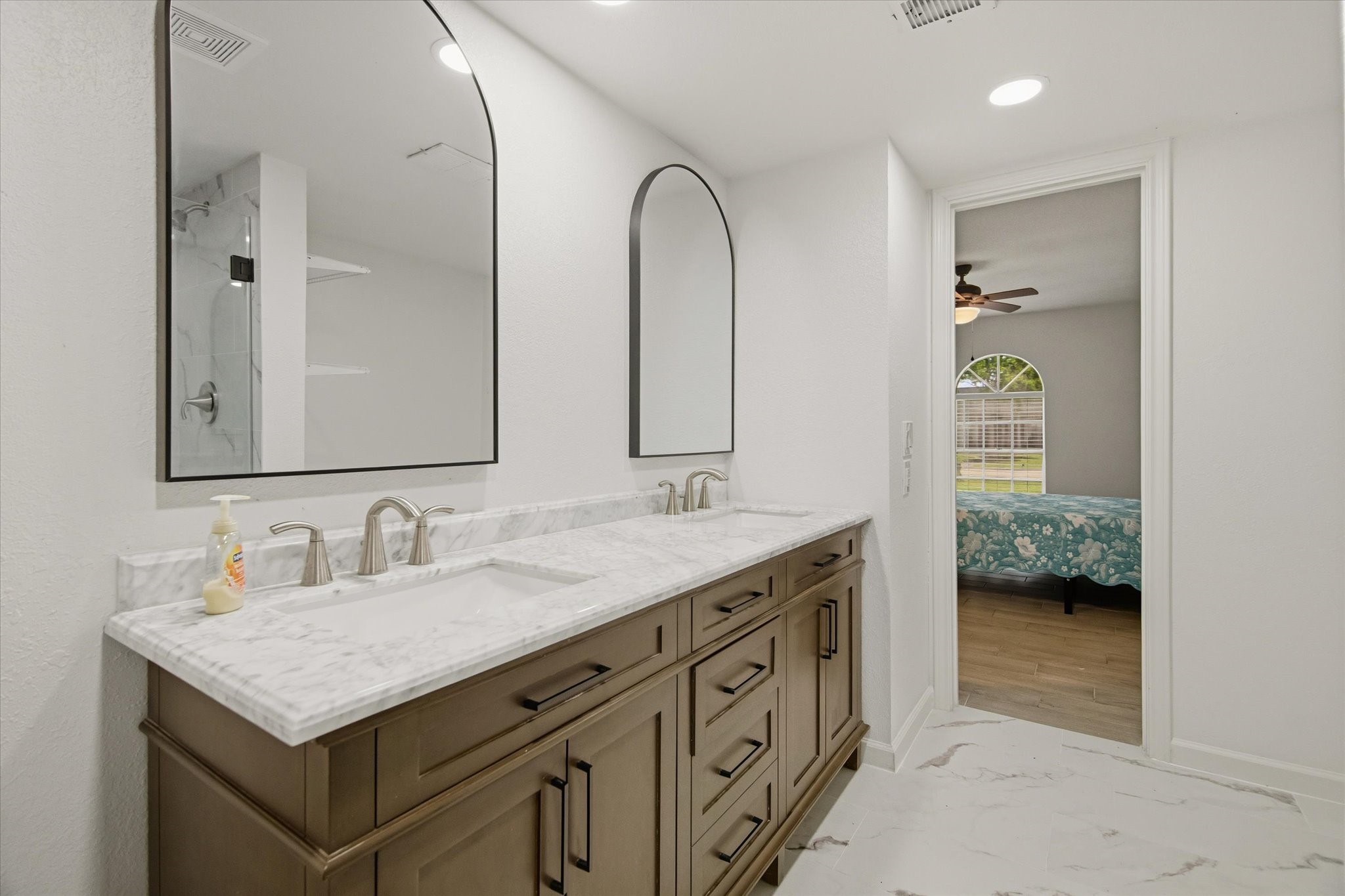 113 Rose Trail Lake Jackson, TX 77566 - Photo 22 of 45 a en suite bathroom with a double vanity sink and a mirror