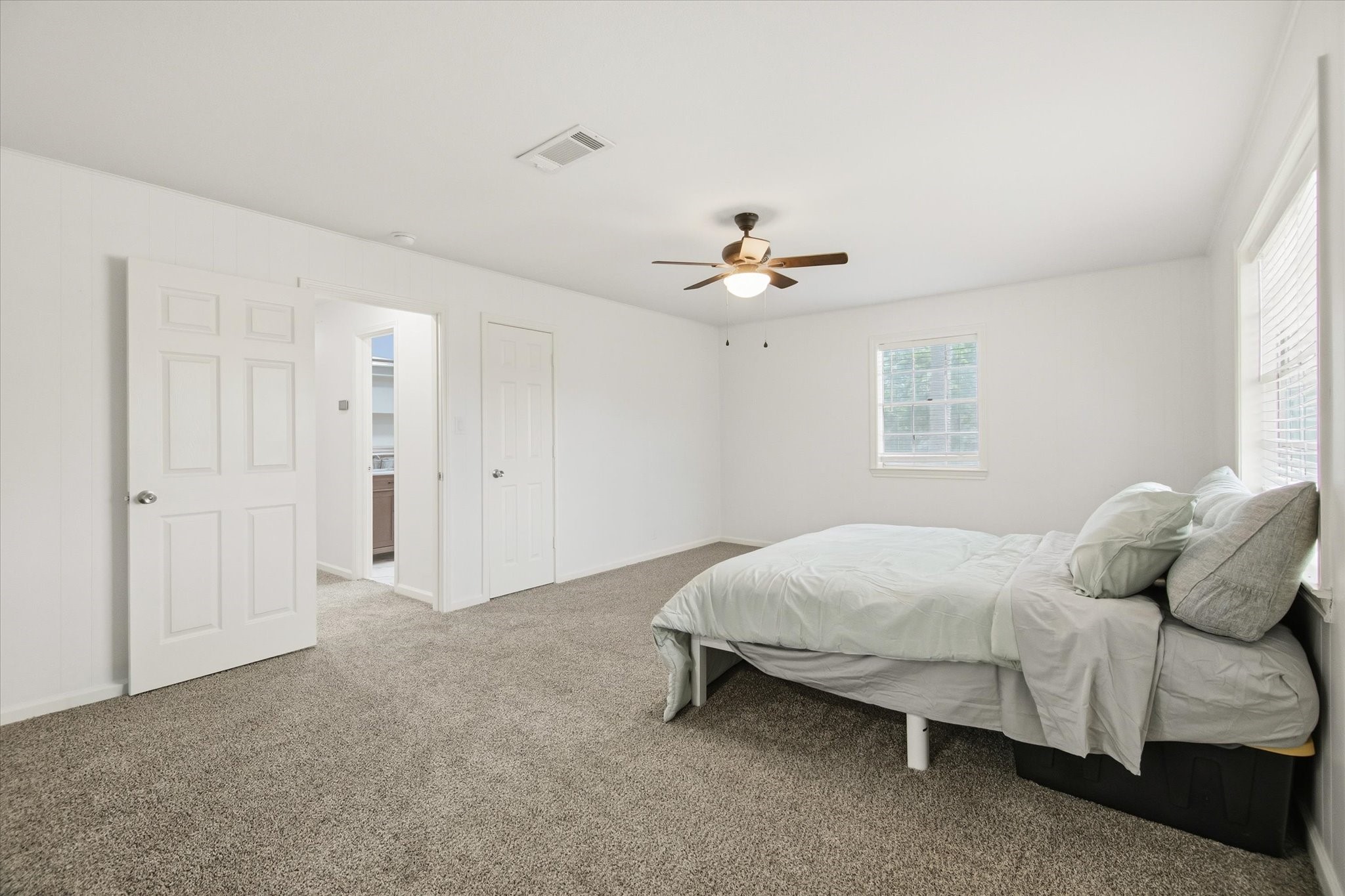 113 Rose Trail Lake Jackson, TX 77566 - Photo 23 of 45 a bedroom with a bed and a chandelier