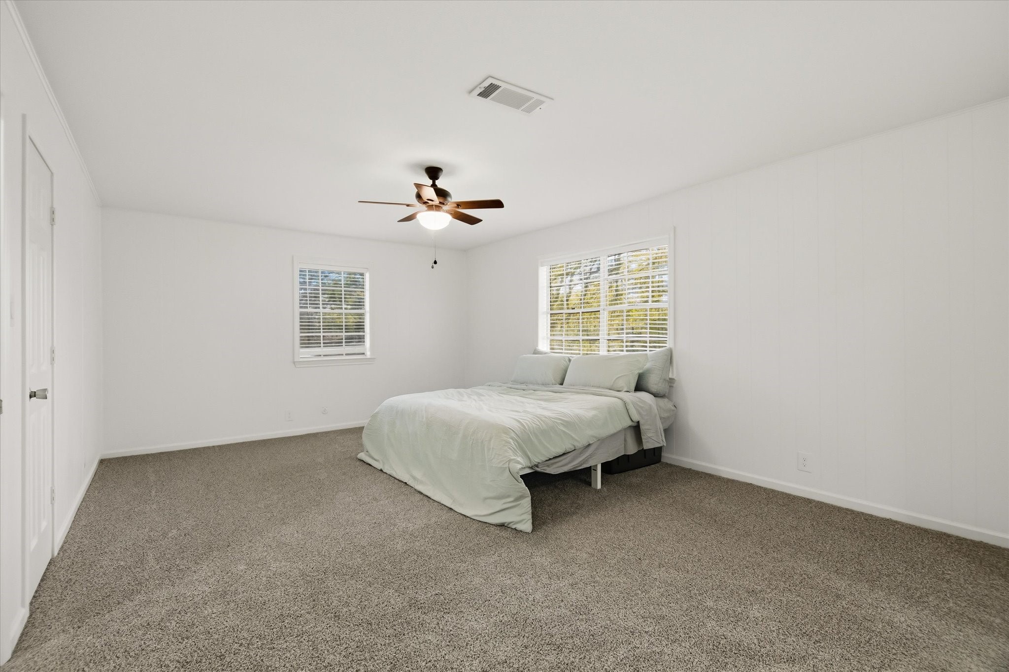113 Rose Trail Lake Jackson, TX 77566 - Photo 24 of 45 a spacious bedroom with a bed and window