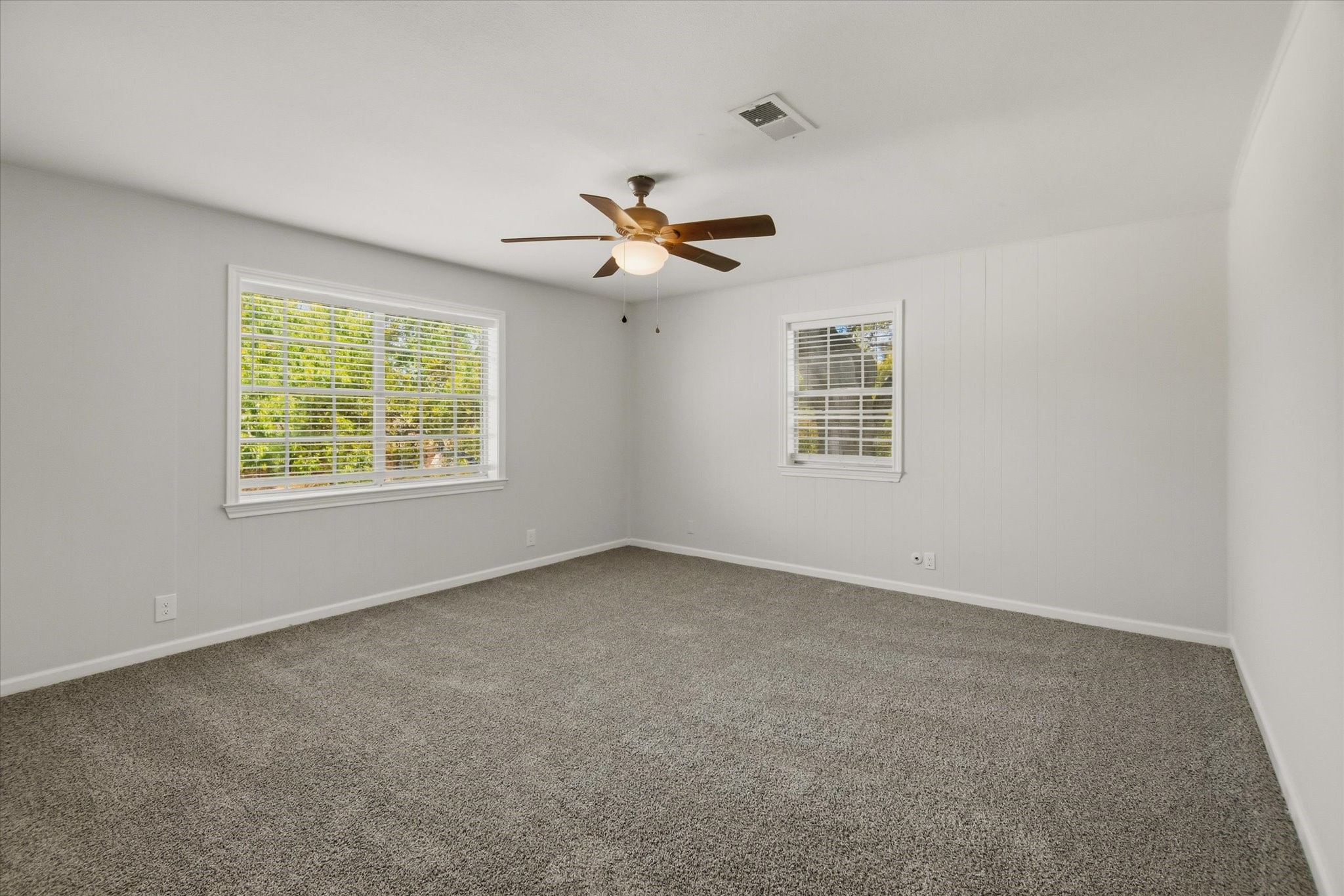 113 Rose Trail Lake Jackson, TX 77566 - Photo 31 of 45 an empty room with windows and chandelier fan