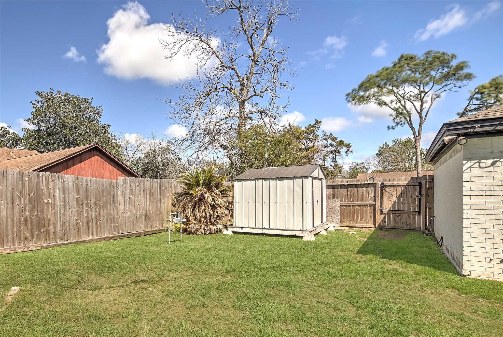 113 Rose Trail Lake Jackson, TX 77566 - Photo 42 of 45 a view of a house with a backyard