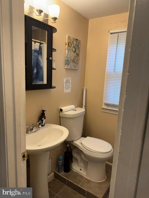 4603 Raleigh Road Temple Hills, MD 20748 - Photo 29 of 40 a bathroom with a toilet sink and mirror