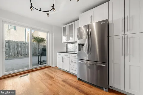 a kitchen with stainless steel appliances granite countertop a sink a stove and cabinets