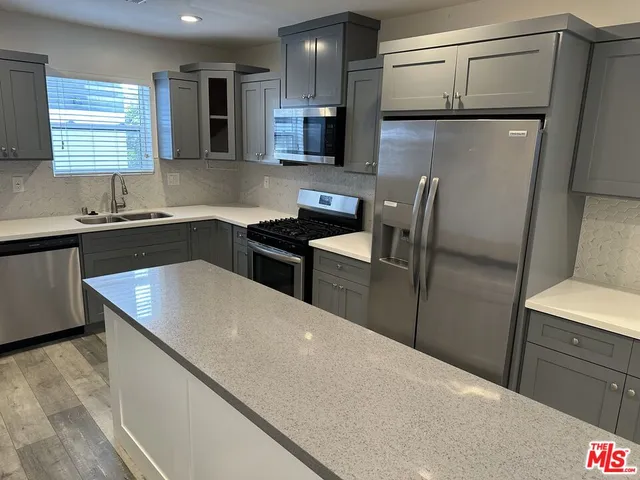 a kitchen with a refrigerator and a sink