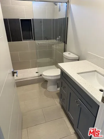 a bathroom with a sink a toilet and a shower