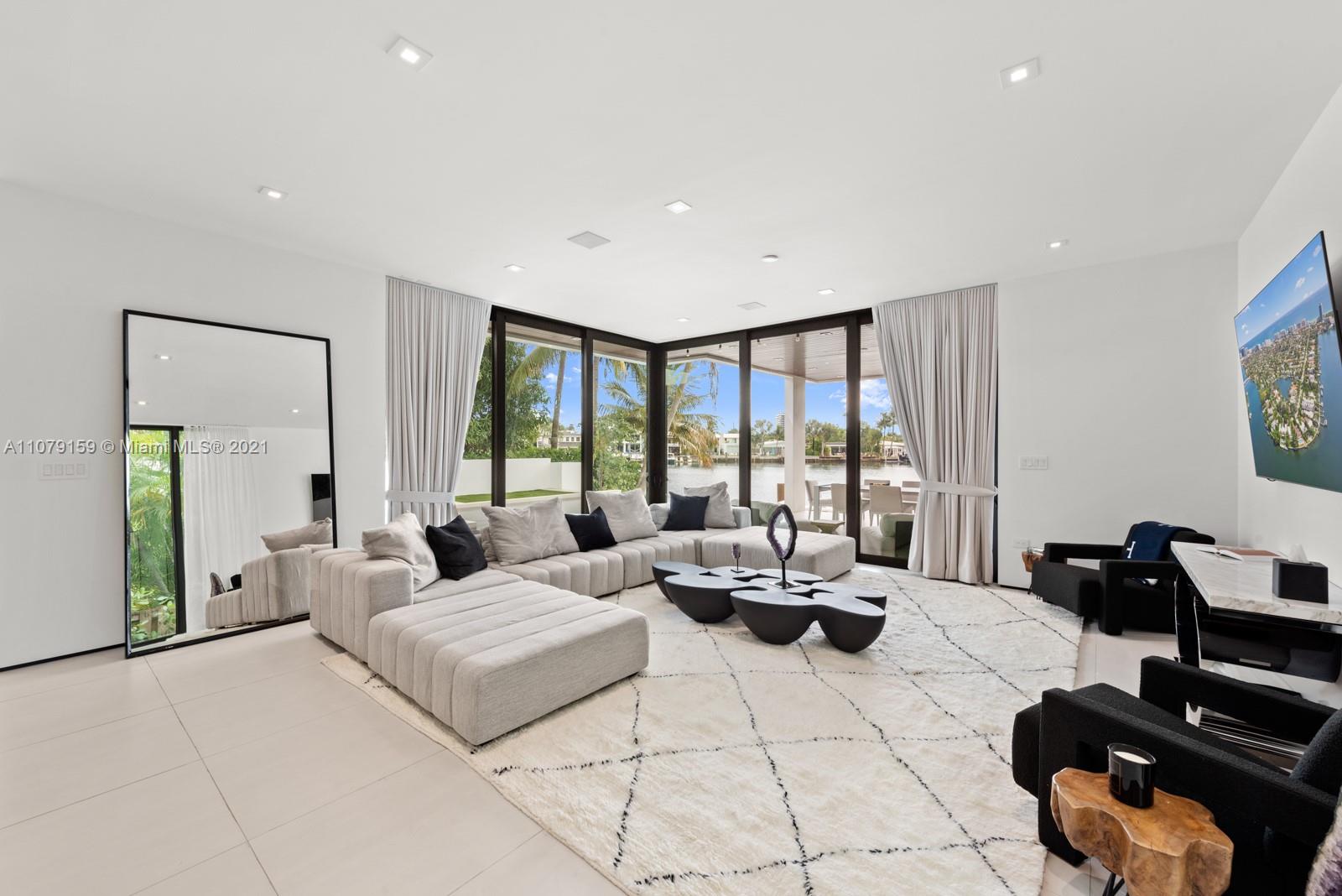 1413 Biscaya Drive Surfside, FL 33154 - Photo 11 of 35 a living room with furniture and large windows