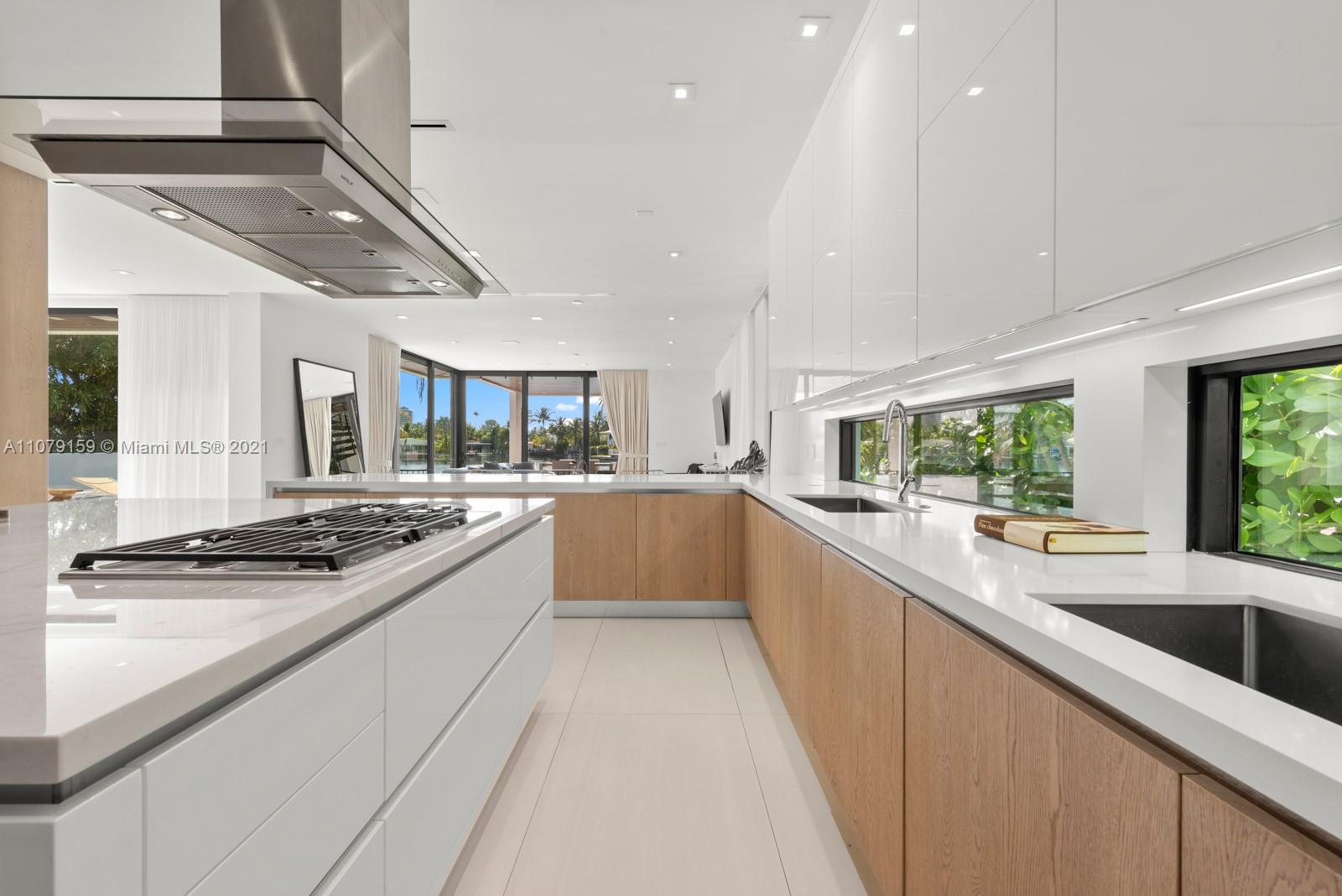 1413 Biscaya Drive Surfside, FL 33154 - Photo 14 of 35 a large kitchen with stainless steel appliances granite countertop a sink and cabinets