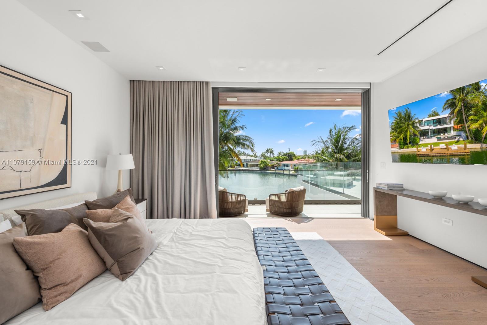 1413 Biscaya Drive Surfside, FL 33154 - Photo 18 of 35 a bedroom with furniture and a large window