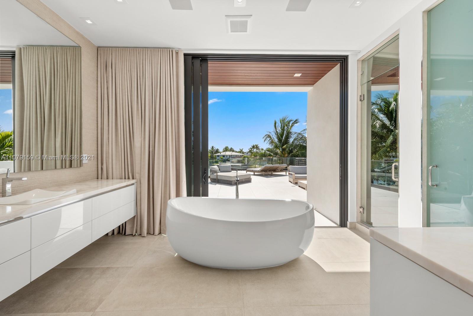 1413 Biscaya Drive Surfside, FL 33154 - Photo 19 of 35 a living room with a large window and a potted plant