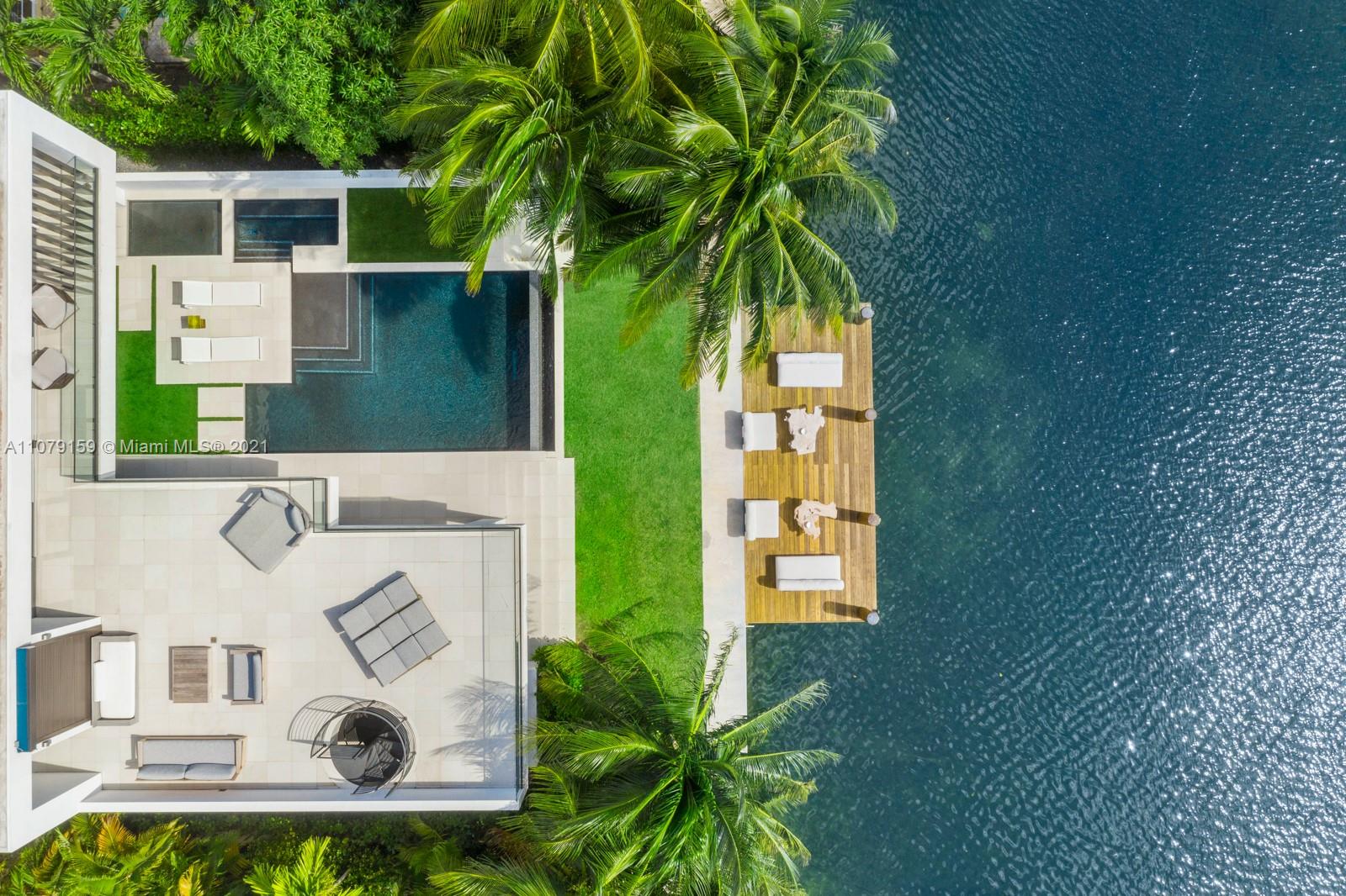 1413 Biscaya Drive Surfside, FL 33154 - Photo 2 of 35 a front view of a house with garden