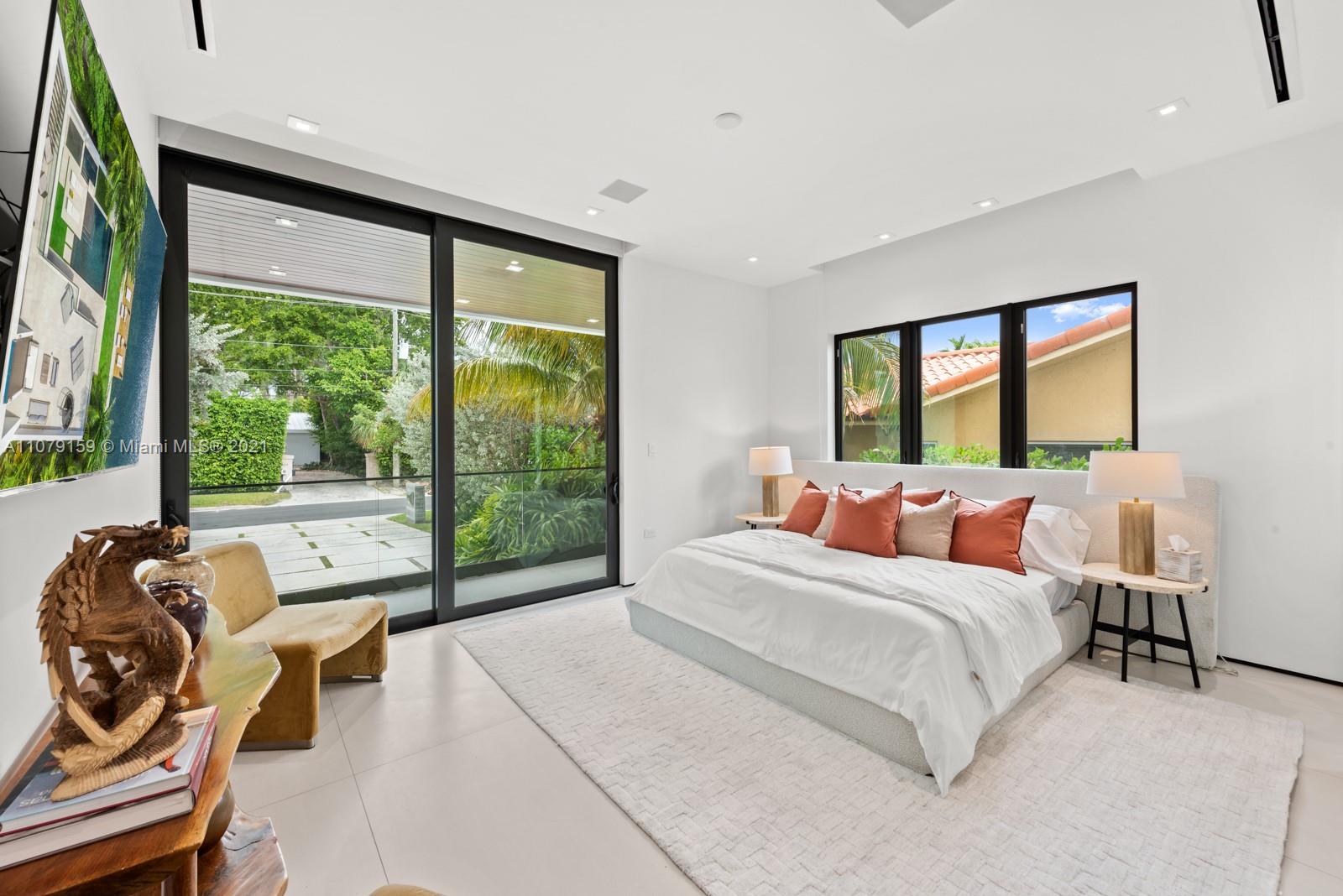 1413 Biscaya Drive Surfside, FL 33154 - Photo 22 of 35 a bedroom with a bed and a large window