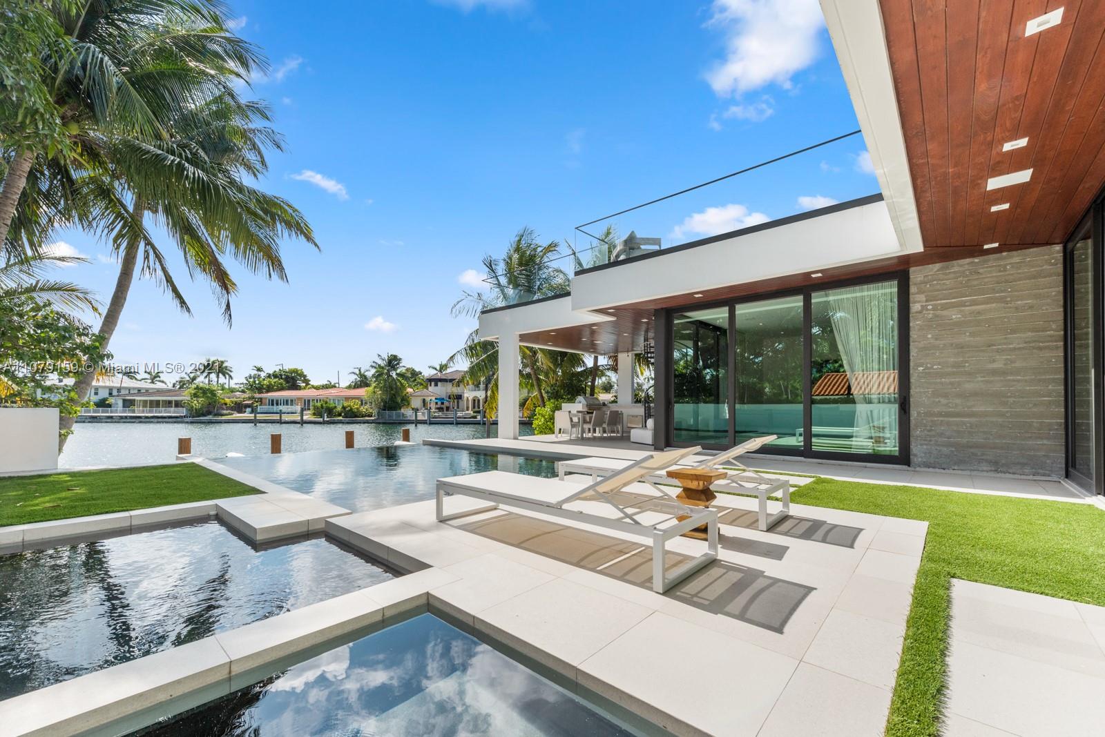 1413 Biscaya Drive Surfside, FL 33154 - Photo 25 of 35 a view of swimming pool with outdoor seating and lake view