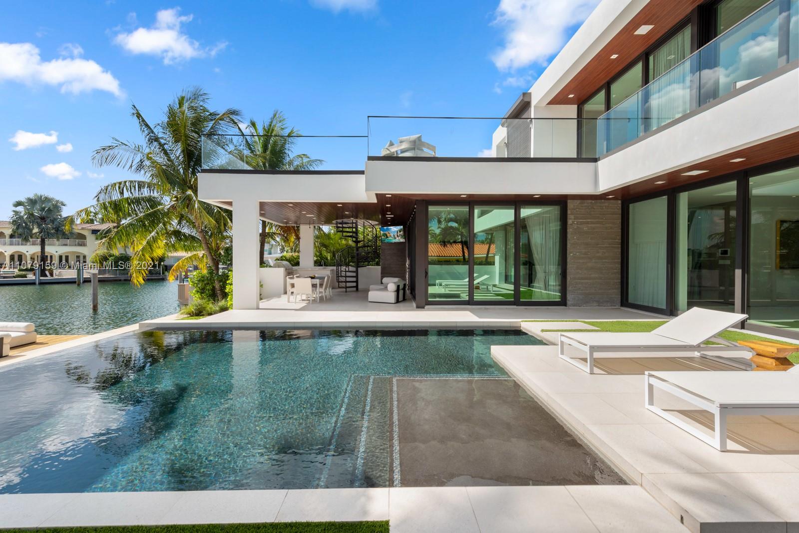 1413 Biscaya Drive Surfside, FL 33154 - Photo 26 of 35 a view of a swimming pool with a patio