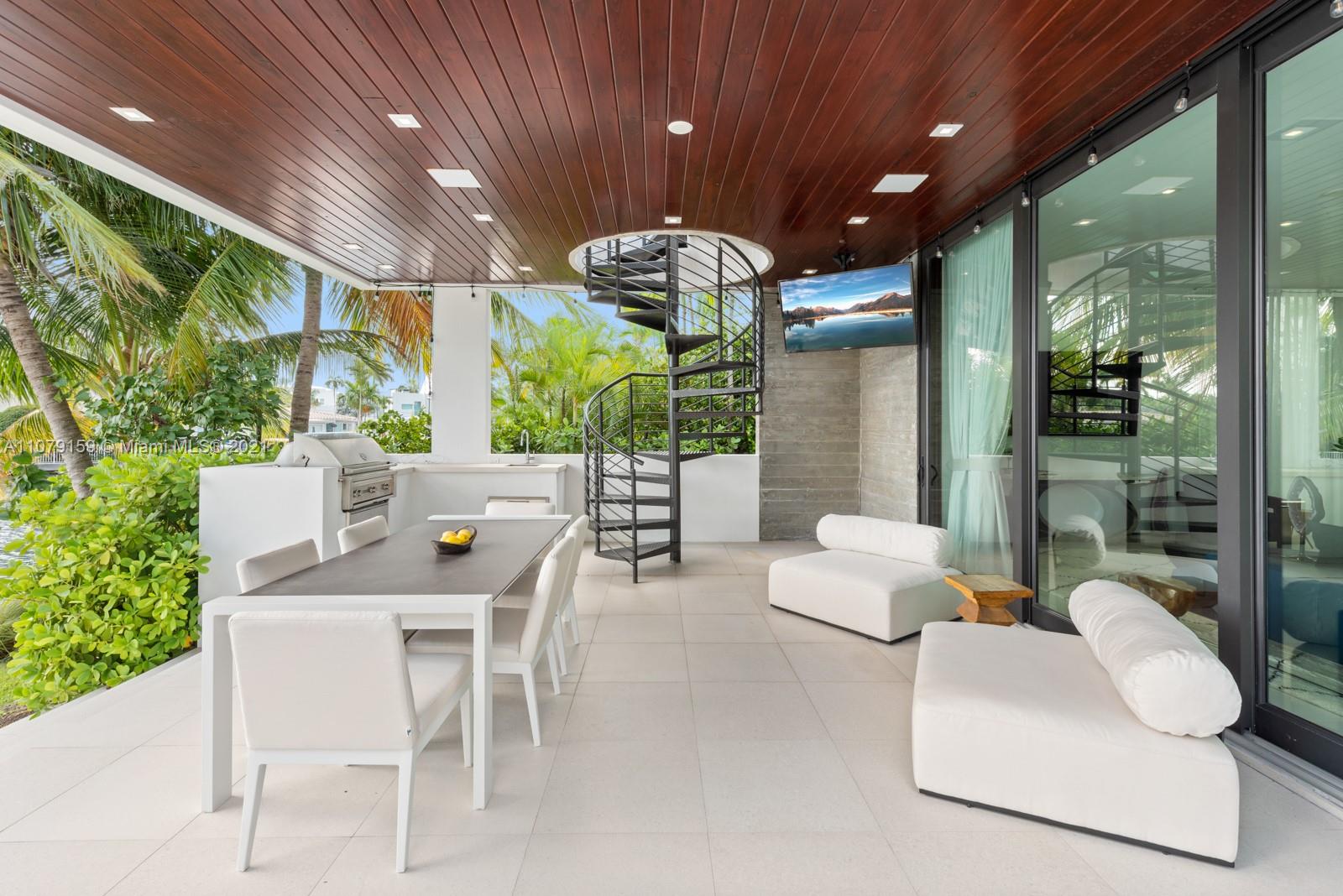 1413 Biscaya Drive Surfside, FL 33154 - Photo 28 of 35 a dining room with furniture and a large window