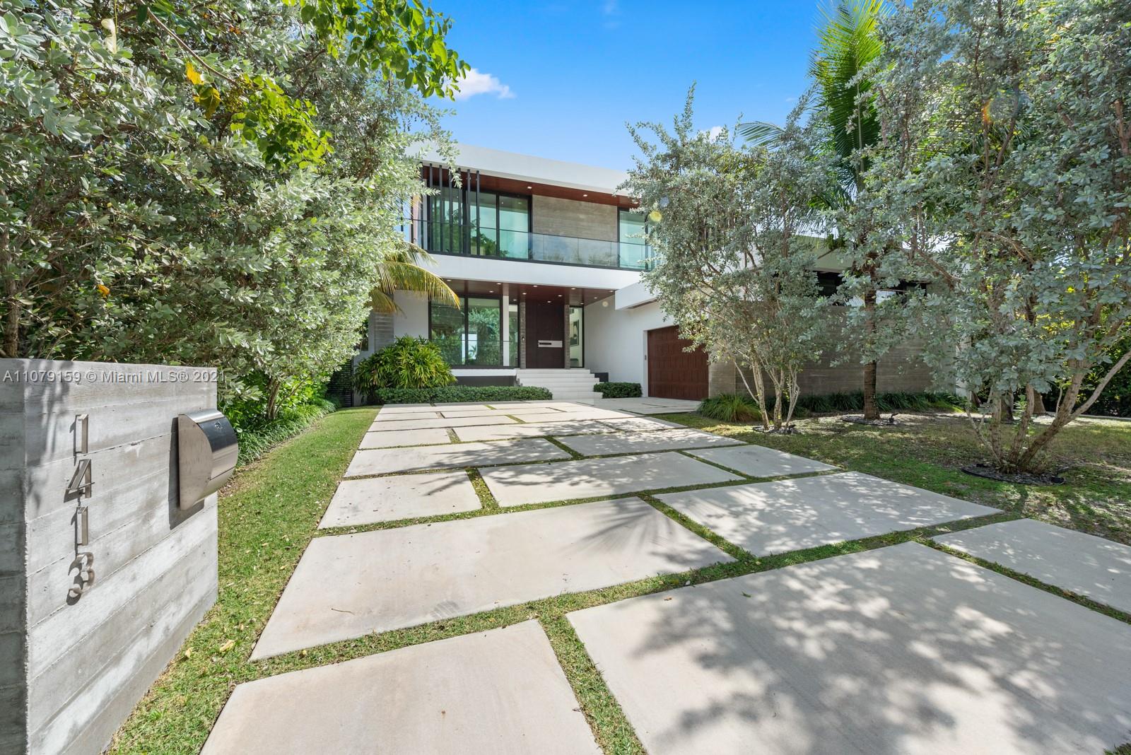 1413 Biscaya Drive Surfside, FL 33154 - Photo 3 of 35 a view of a white house with a yard