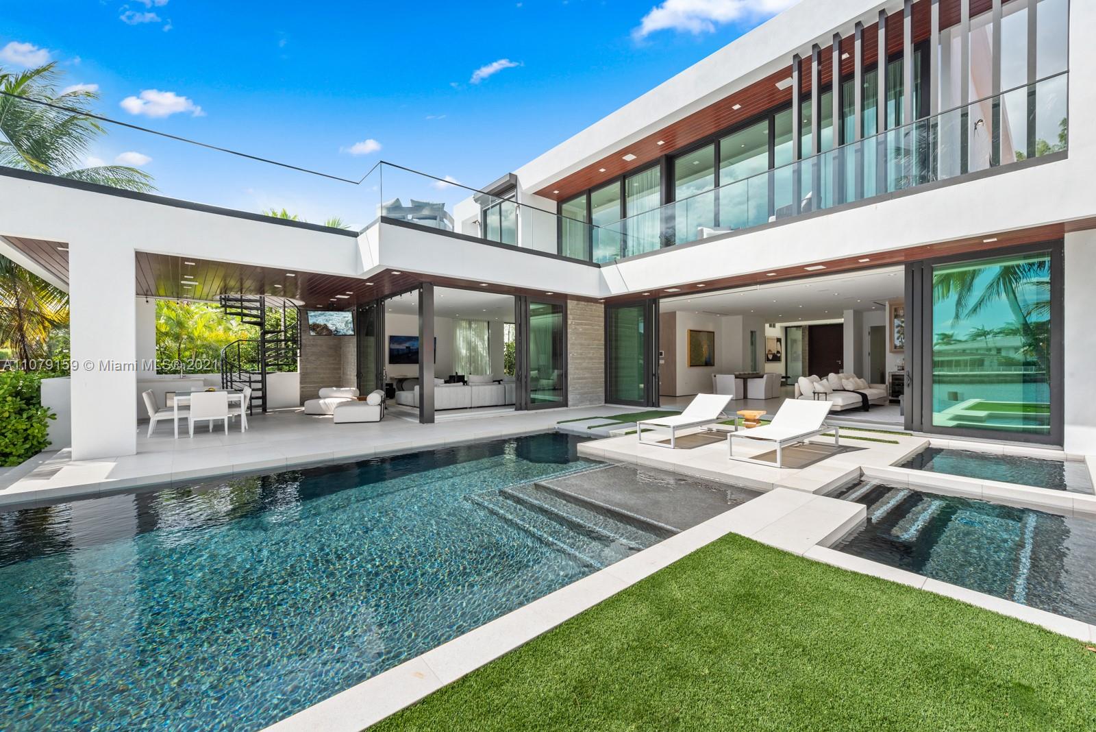 1413 Biscaya Drive Surfside, FL 33154 - Photo 34 of 35 a view of a patio with table and chairs potted plants and floor to ceiling window