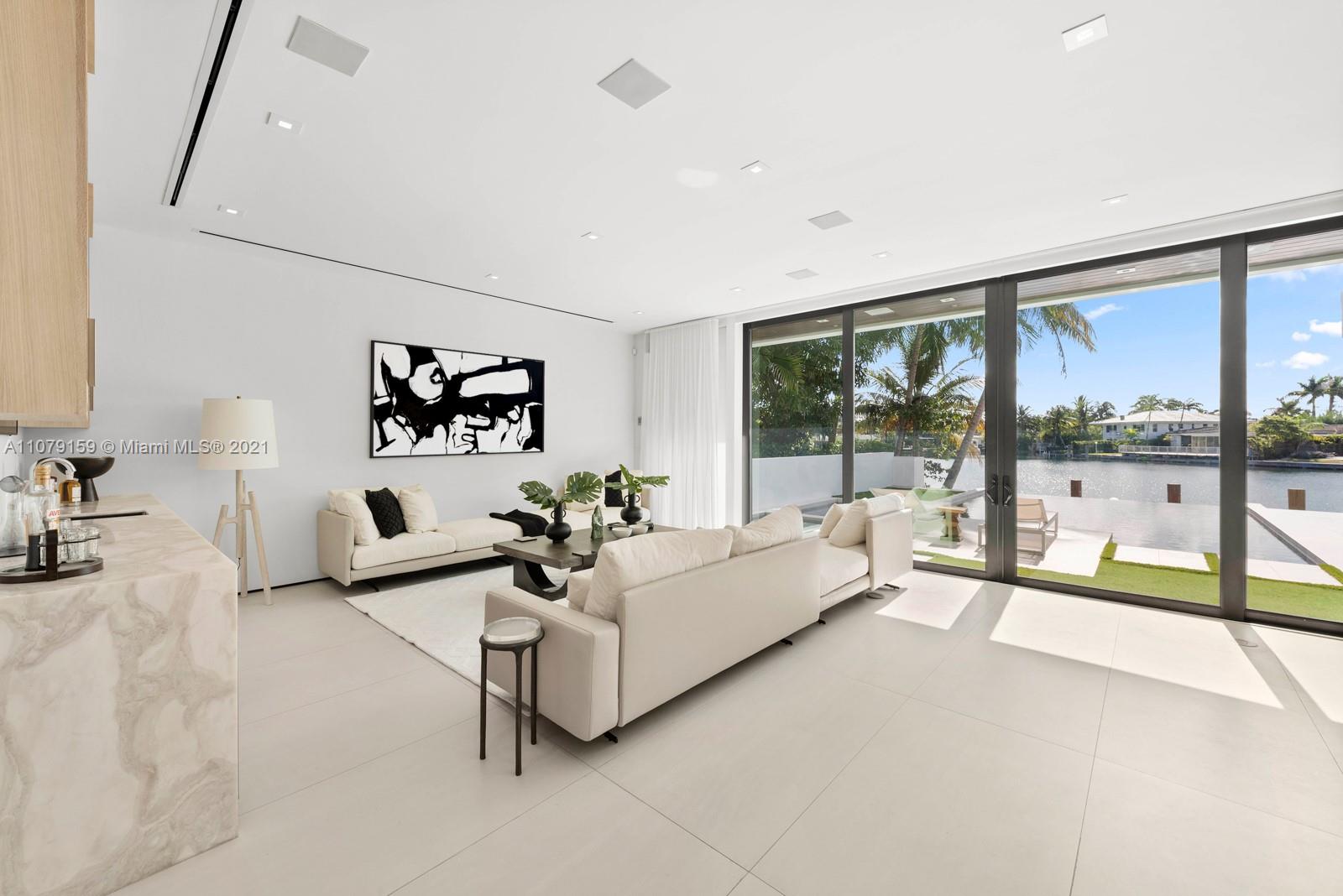 1413 Biscaya Drive Surfside, FL 33154 - Photo 9 of 35 a living room with furniture and a large window