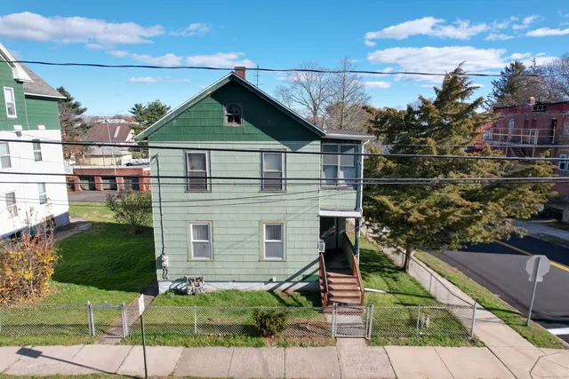 a view of a house with a small yard