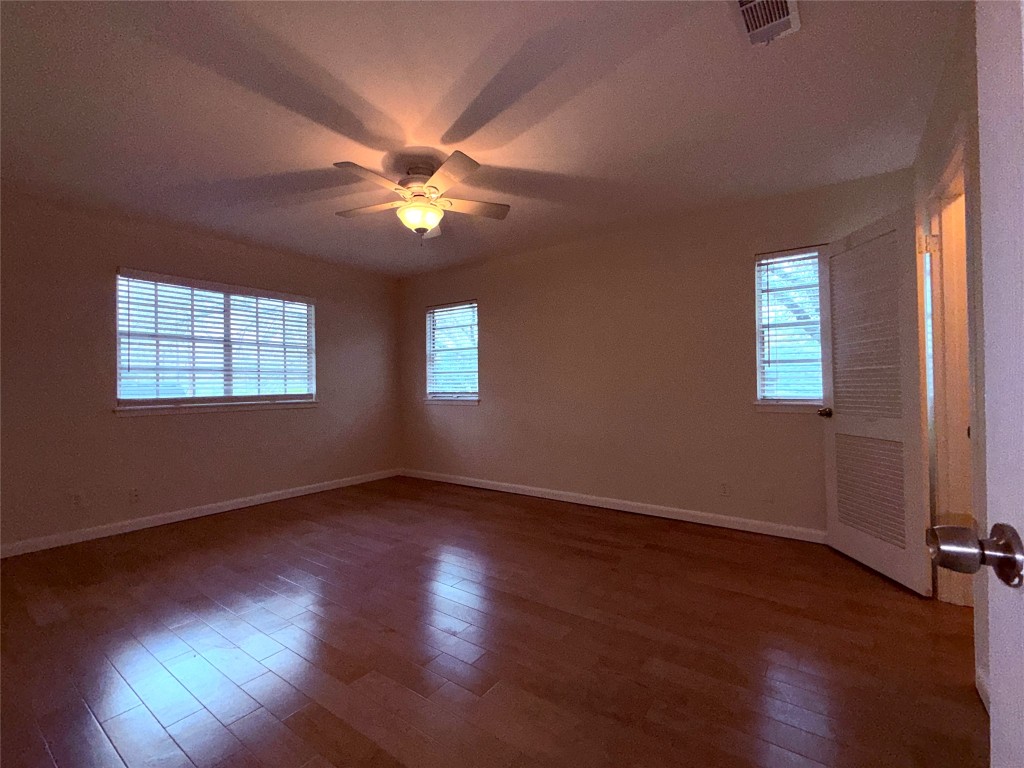 5413 Coventry Lane Austin, TX 78723 - Photo 17 of 25 a view of an empty room with wooden floor and a window