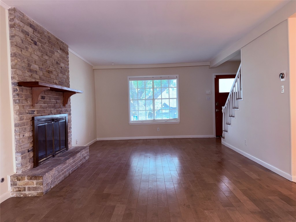 5413 Coventry Lane Austin, TX 78723 - Photo 2 of 25 an empty room with wooden floor fireplace and windows