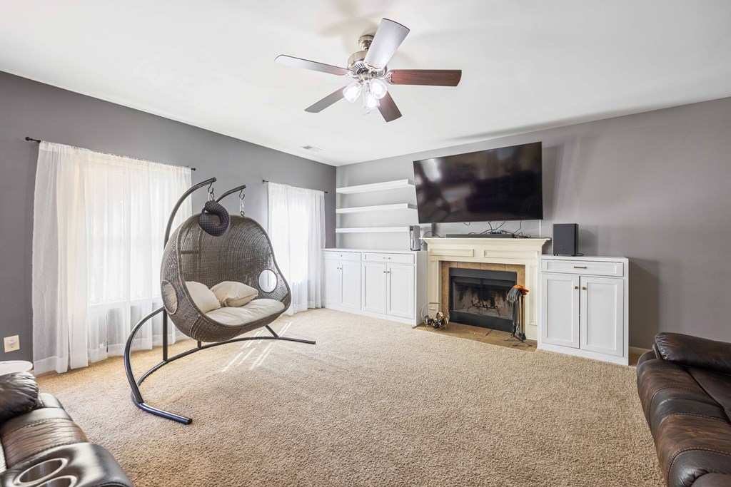 4936 Brightstar Lane Columbus, GA 31907 - Photo 19 of 42 a living room with furniture a flat screen tv and a fireplace