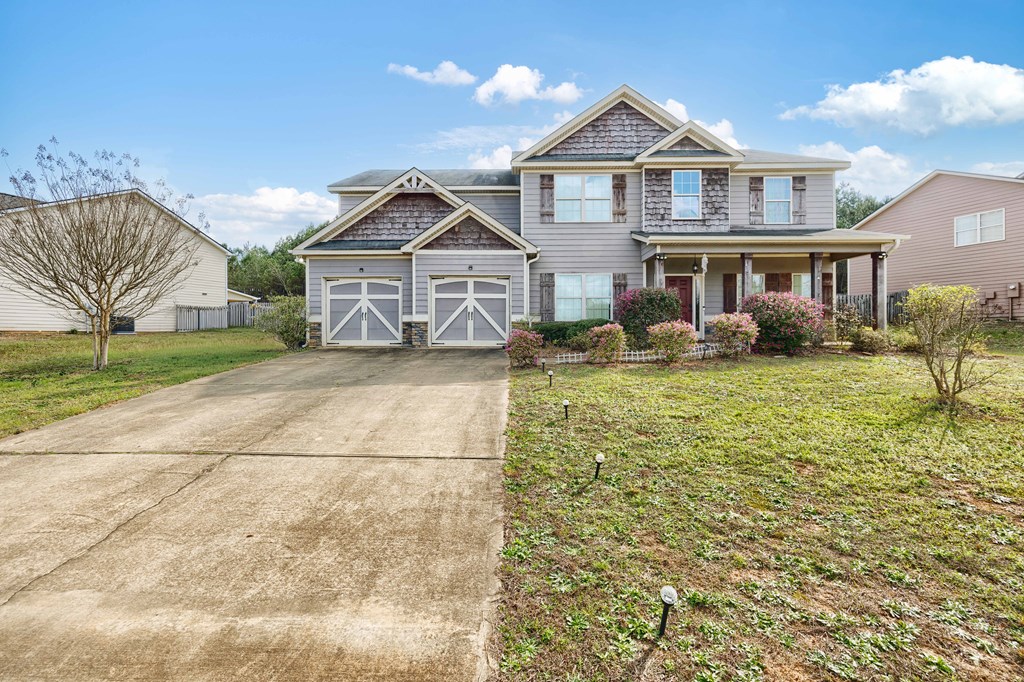 4936 Brightstar Lane Columbus, GA 31907 - Photo 2 of 42 a view of a white house next to a yard with big trees