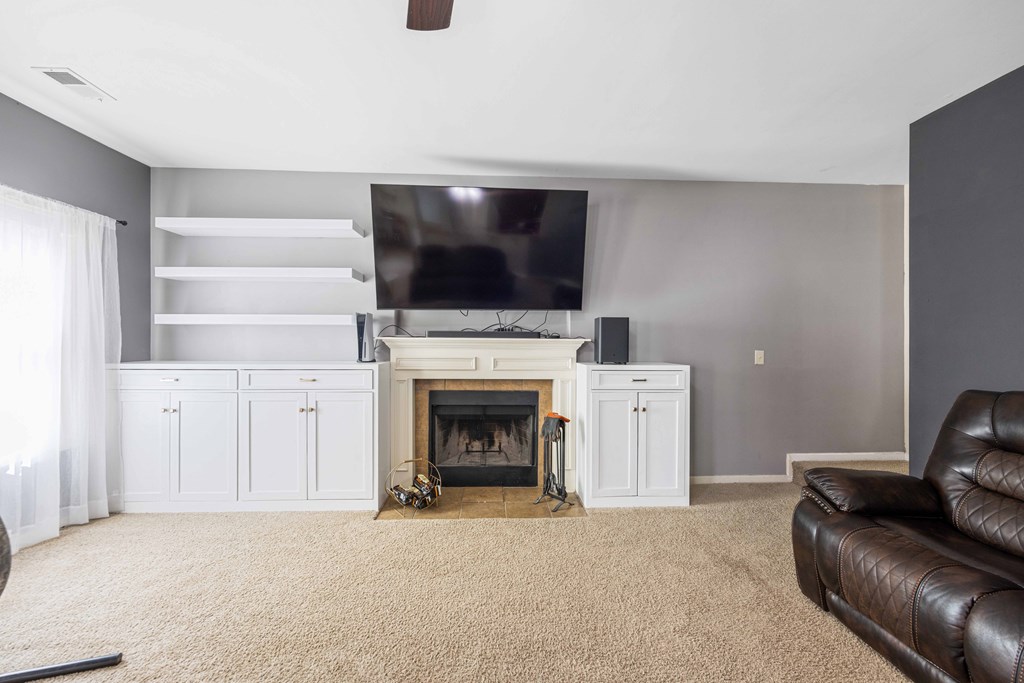 4936 Brightstar Lane Columbus, GA 31907 - Photo 22 of 42 a living room with furniture a flat screen tv and a fireplace