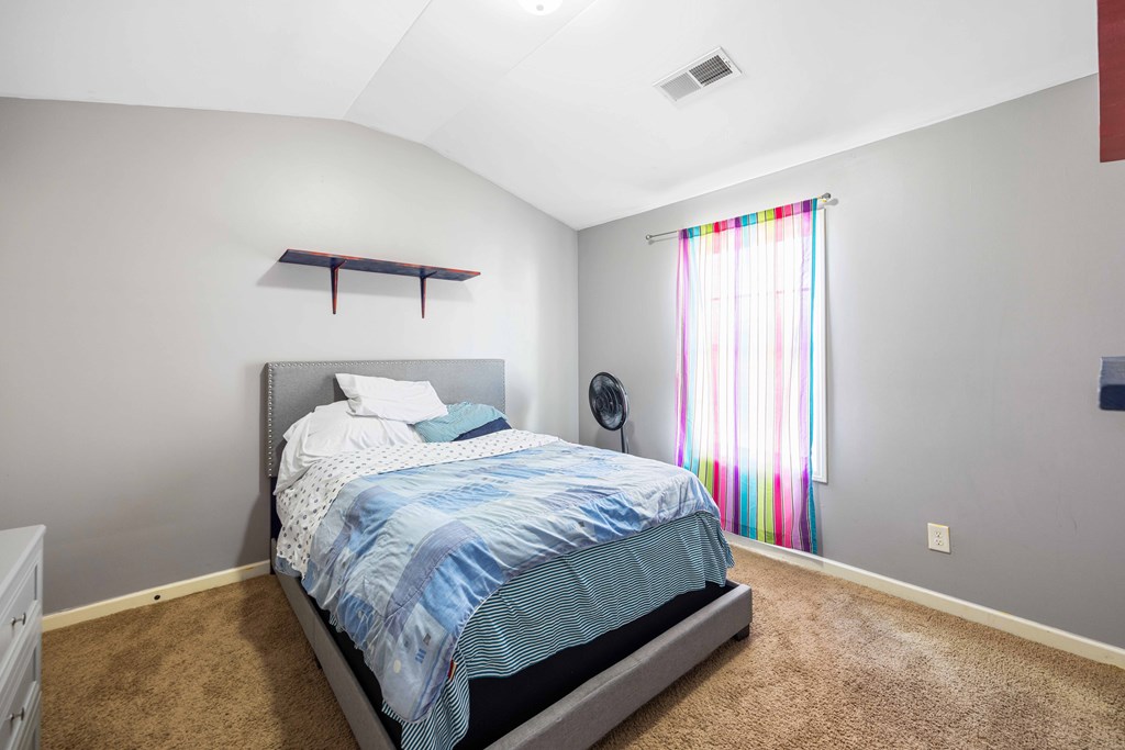 4936 Brightstar Lane Columbus, GA 31907 - Photo 24 of 42 a bed sitting in a bedroom next to a window