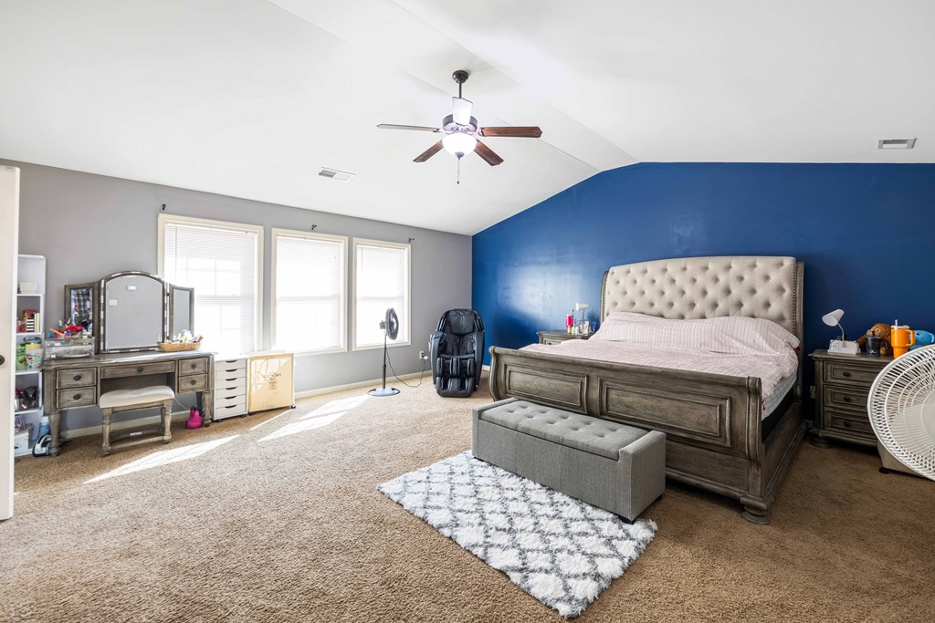 4936 Brightstar Lane Columbus, GA 31907 - Photo 25 of 42 a bedroom with a bed and a chandelier