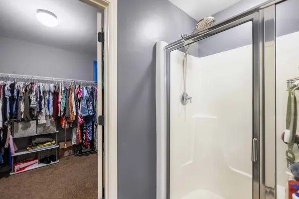 a view of walk in closet with clothes