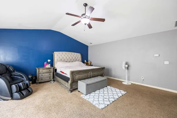 a bedroom with furniture and wooden floor