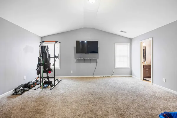 an empty room with furniture and gym equipment