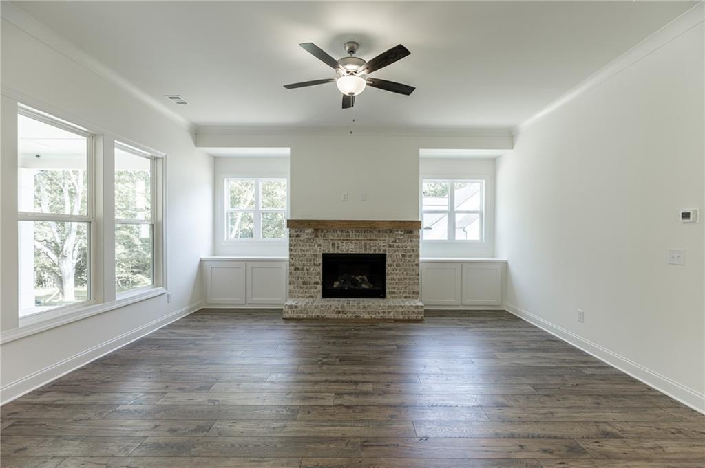 1210 Austin Road Winder, GA 30680 - Photo 22 of 56 an empty room with windows a fireplace
