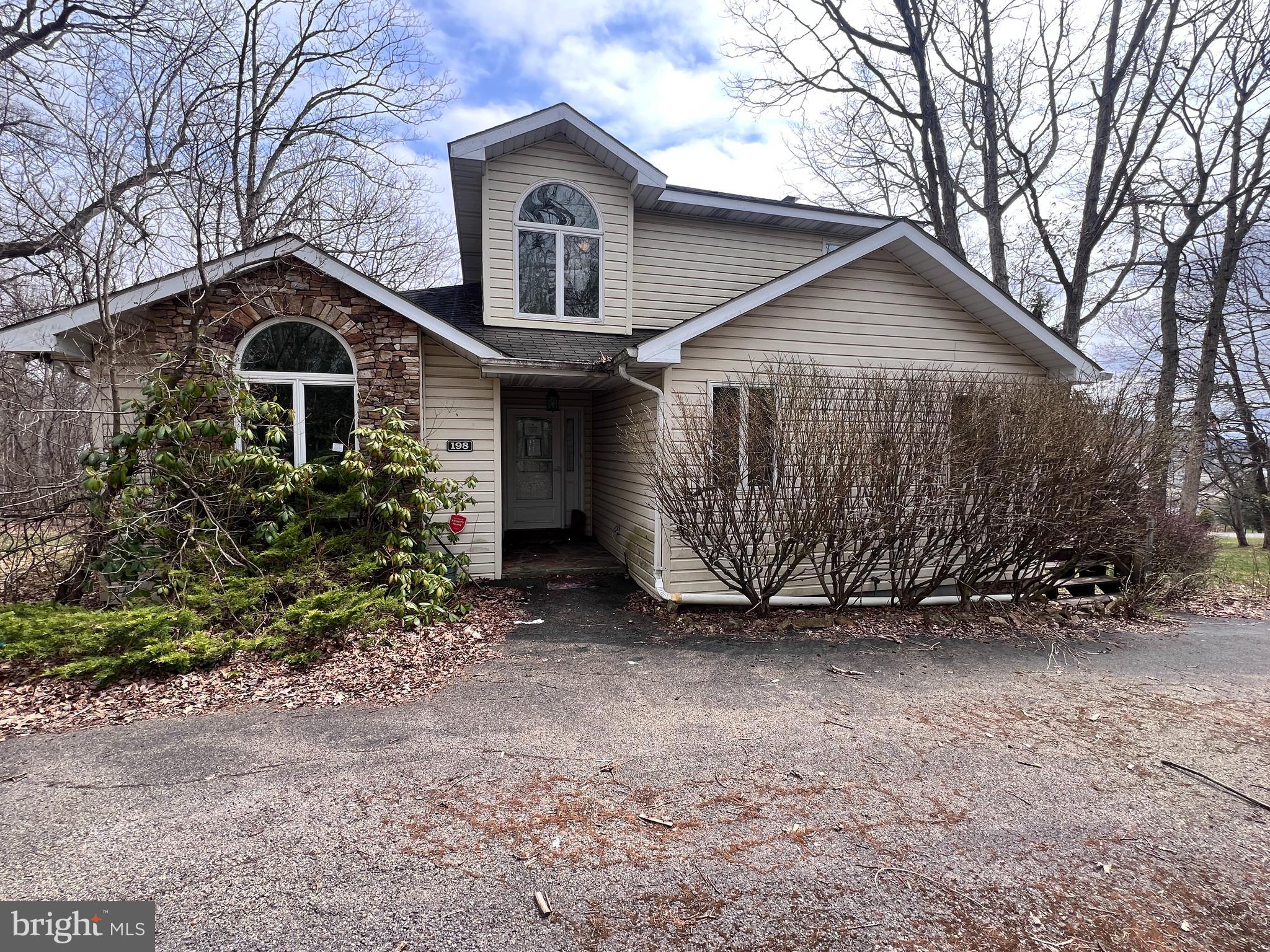 a view of a house with a yard and garage