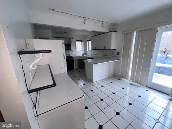 a kitchen with a sink cabinets and wooden floor