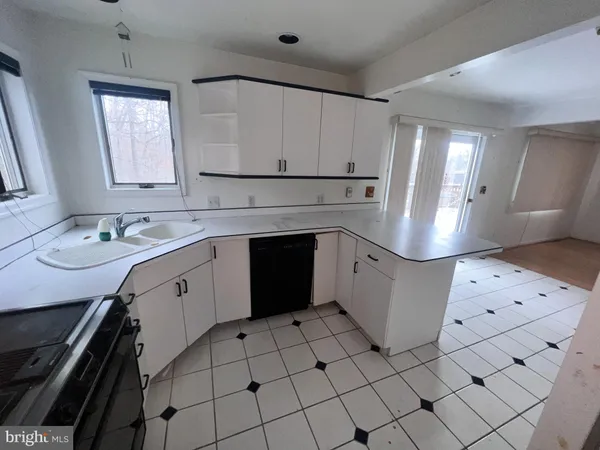 a kitchen with stainless steel appliances a refrigerator and a stove top oven