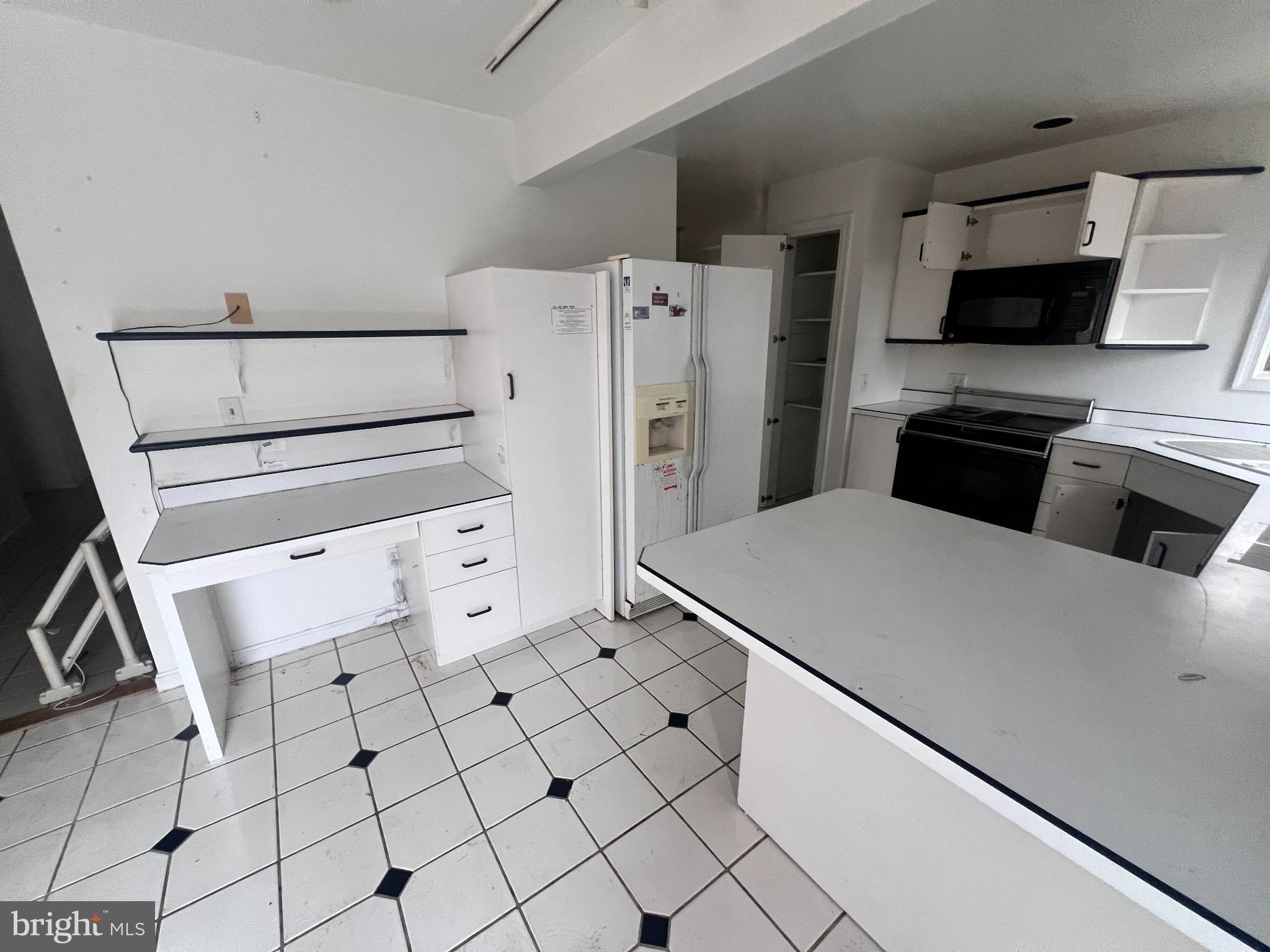 198 Pysell Road McHenry, MD 21541 - Photo 15 of 47 a kitchen with white cabinets and white appliances