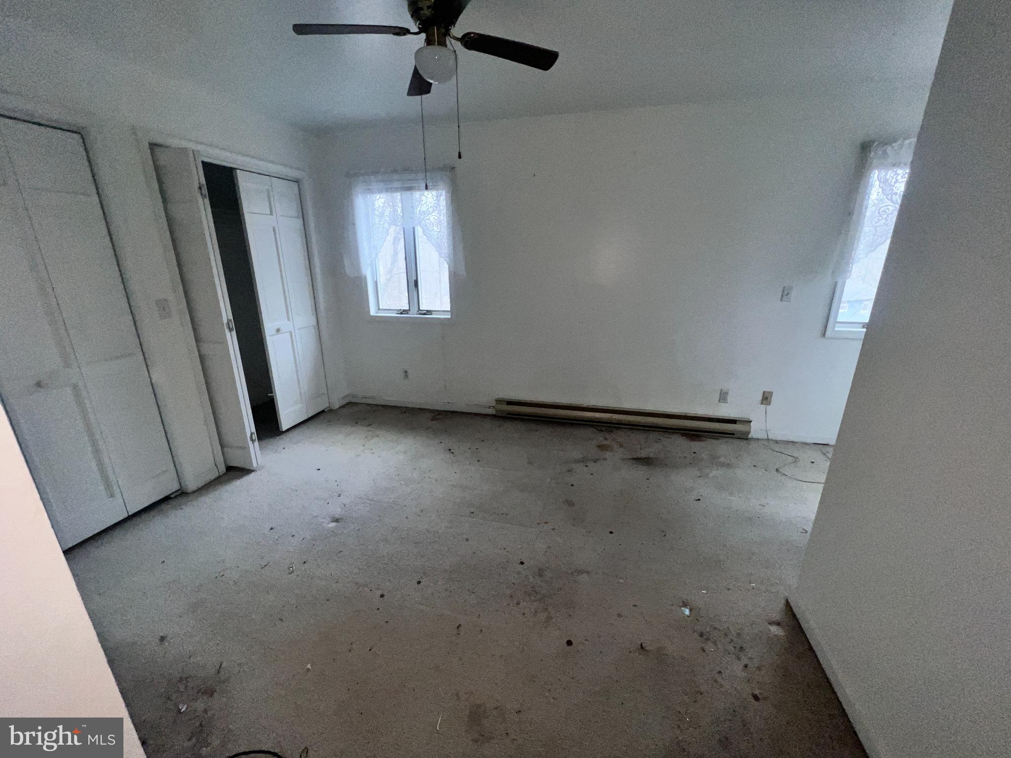 198 Pysell Road McHenry, MD 21541 - Photo 31 of 47 an empty room with a ceiling fan and window