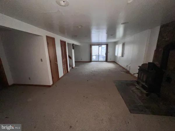 a view of a house with backyard and chairs