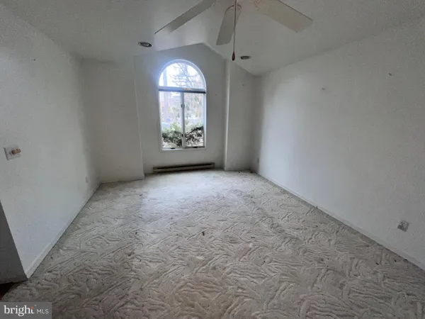 a view of a livingroom with a ceiling fan and window