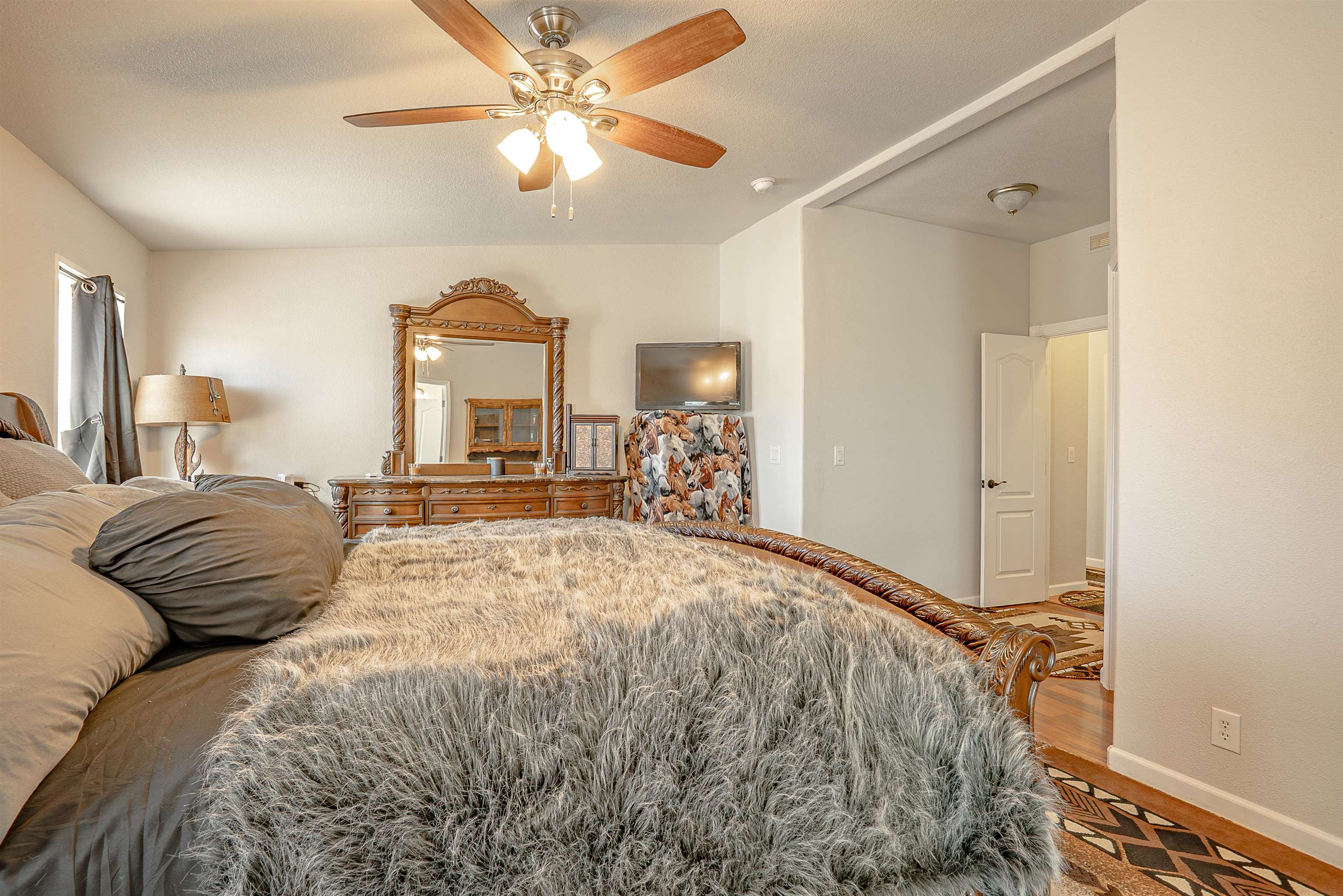 714-100 Sears Road Janesville, CA 96114 - Photo 27 of 35 a bedroom with a large bed and a chandelier